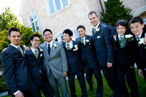 smiling groomsmen in black suits with olive green ties and groom in grey suit with black tie - wedding party group portrait - photo by Seattle based wedding photographers La Vie Photography 